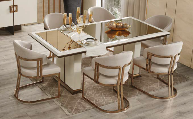 Elegant modern dining table with mirrored top and gold-accented chairs in a chic dining room.