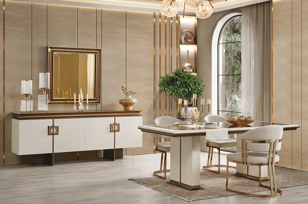Luxurious dining room with a white and gold sideboard, a chandelier, and a marble-topped table set for a formal meal near a large arched window.