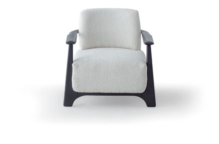 Cream textured armchair with dark curved legs and armrests, shown against a white background.