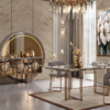 Luxurious dining room with a glass top table gray upholstered chairs and gold metal frames against marble walls and a circular illuminated mirror