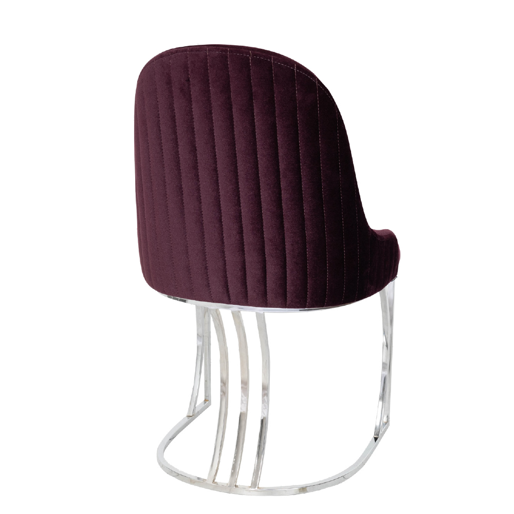 Burgundy velvet upholstered chair with vertical stitching and a chrome curved pedestal base
