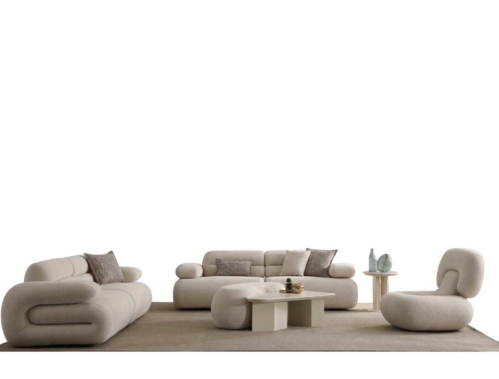 Cream-colored modular sofa with rounded edges and matching ottomans in a minimalist living room.