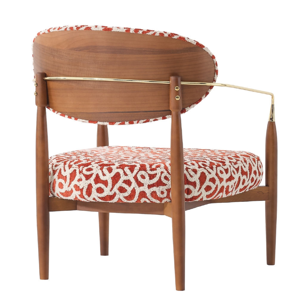 Mid-century wooden armchair with red and white patterned upholstery and a brass spine bar.