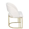 Modern white upholstered accent chair with a curved back and gold metal sled base with a white cushion
