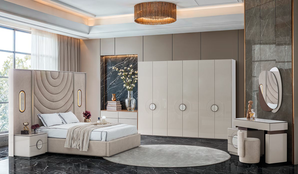 Luxurious modern bedroom showroom with a beige upholstered bed, circular rug, and white wardrobe cabinets.