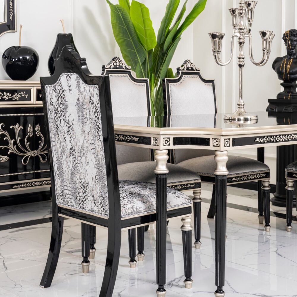Luxurious black-and-silver dining room with snakeskin-upholstered chairs around a glossy table and a tall green plant in the background