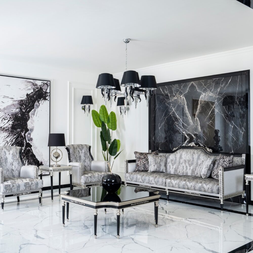 Luxurious black-and-silver living room with marble floors and ornate furniture accents.