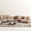 Creambeige sectional sofa with cushions in a bright minimalist living room centered on a gray rug and low tables