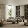 Contemporary living room with neutral sofas a textured stone wall and tall built in bookshelves flanking a fireplace Large windows with sheer curtains bring in natural light