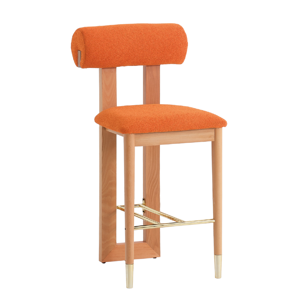 Wooden bar stool with orange upholstered seat and backrest, gold-toned footrest, and tapered legs with metallic tips.