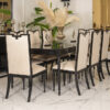 Elegant dining room with a long black table and beige upholstered chairs pampas grass centerpiece on a marble floor