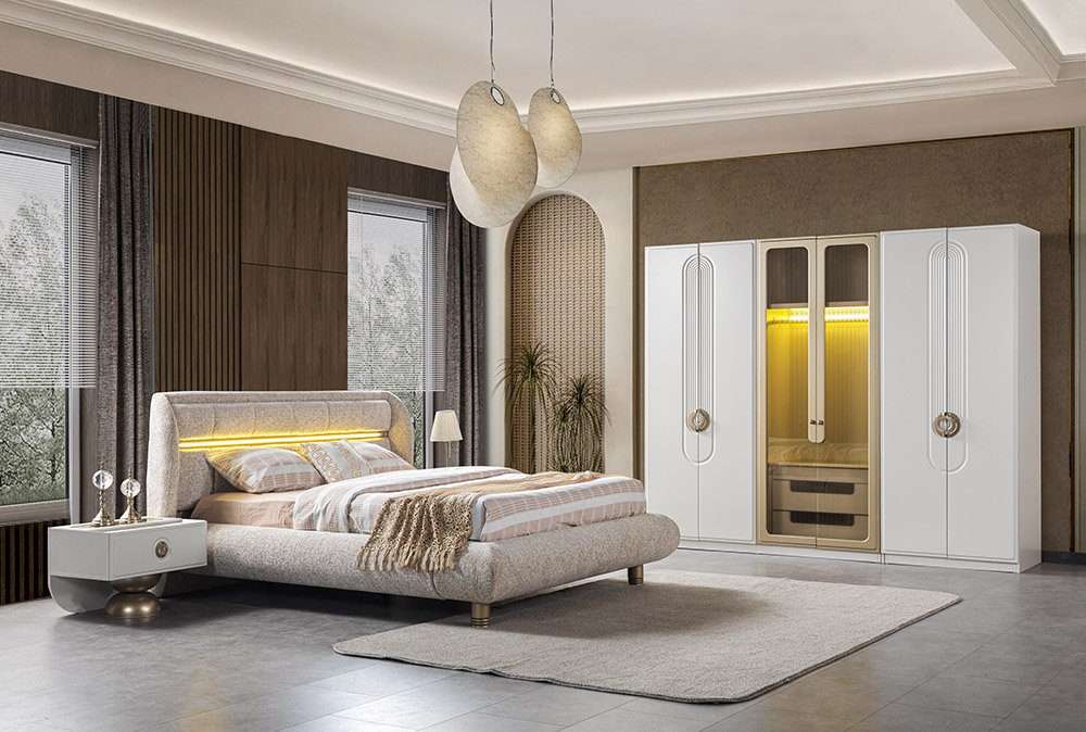 Modern bedroom with a beige upholstered bed, white nightstand, rug, and a large white wardrobe with a central glass display cabinet.