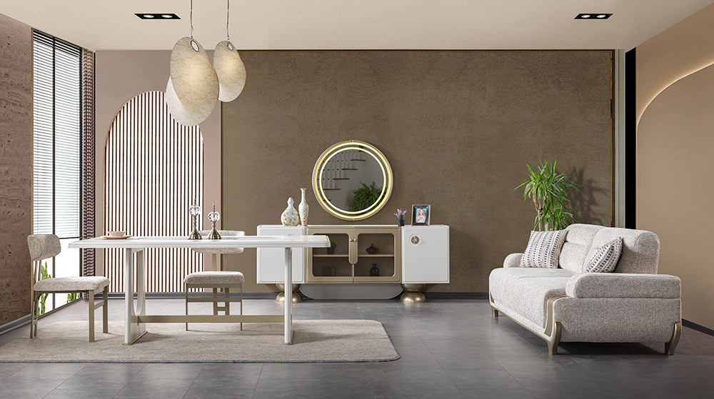 Modern living room with a white dining table and chairs, beige sofa, circular wall mirror, and plants in a neutral-toned space.