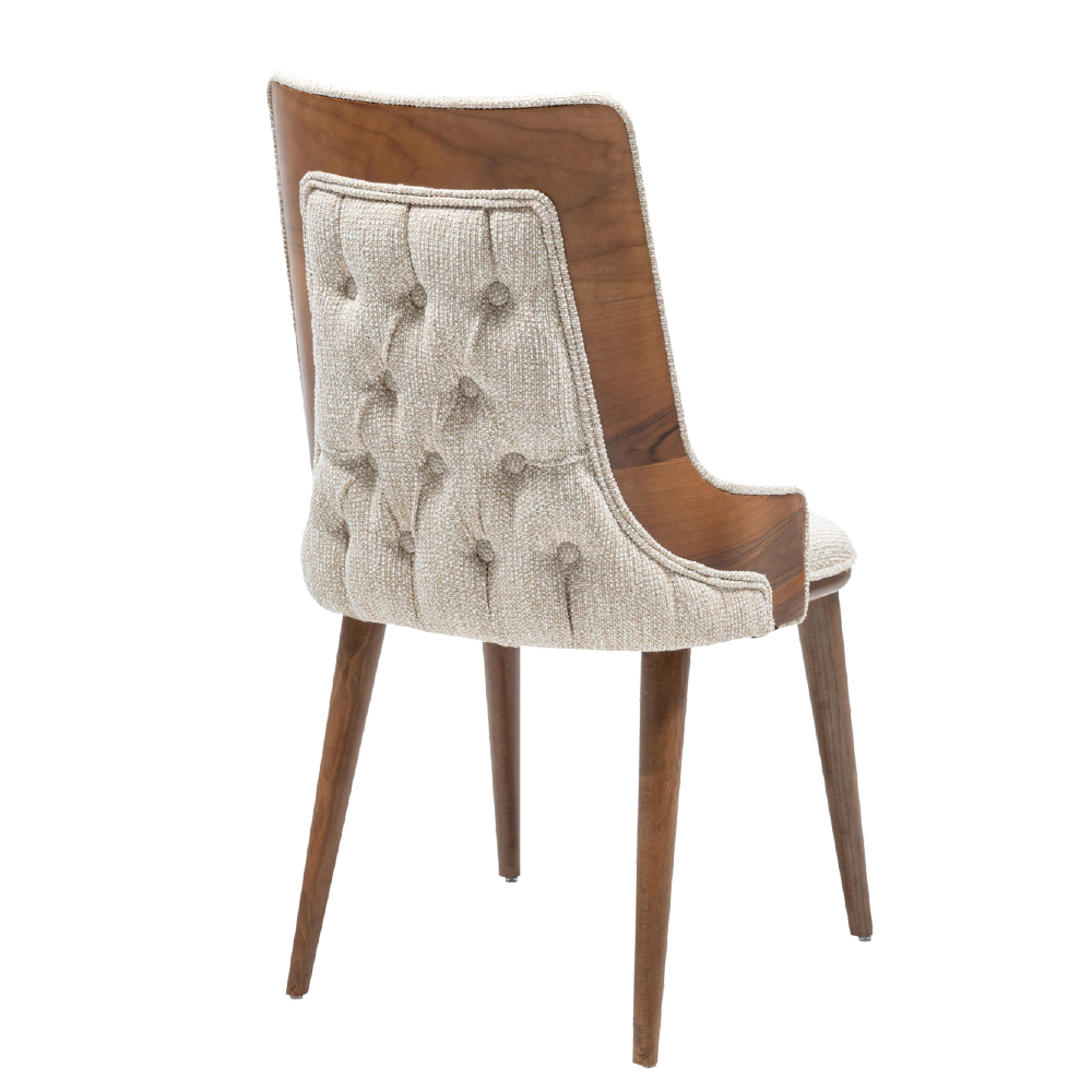 Wooden mid century chair with beige tufted fabric upholstery on the back and seat curved sides and four tapered legs