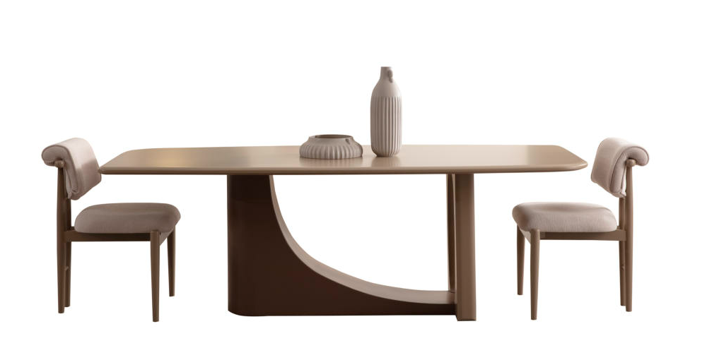 Beige dining table with a curved pedestal base and two matching chairs, vase and decorative tray centered on the table.