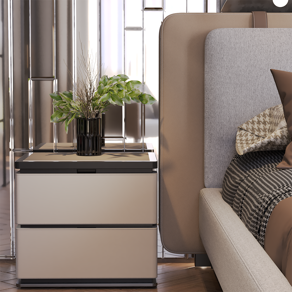Venedik Bedroom Custom Production 3 Armonna Beige two drawer nightstand with a black vase of green leaves and dried stems beside a beige upholstered bed with a gray headboard and plaid blanket