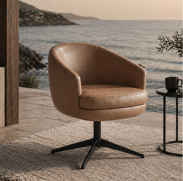 Tan leather swivel chair on a patio by the sea, with a round black base and nearby side table.