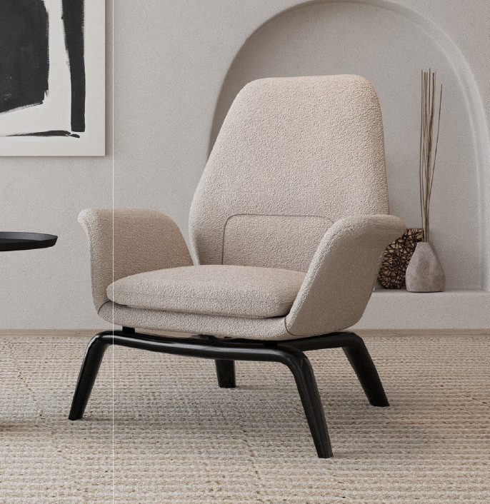 Cream boucle armchair with black angled legs in a neutral living room on a textured rug.