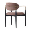 Mid century style chair with pink textured upholstery black tapered legs and a brass back bar joining the arms
