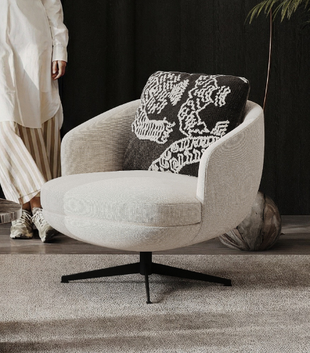 Round beige fabric swivel chair with black metal base and a black‑and‑white patterned cushion in a cozy living room.