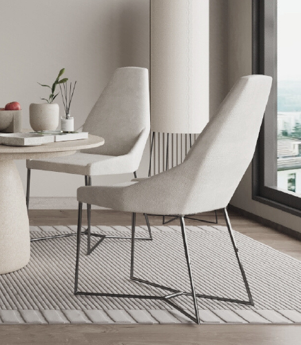 Bright dining area with beige upholstered chairs around a round white table, a plant centerpiece, and a large window view.