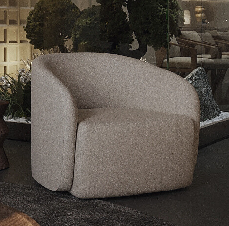 Beige curved armchair in a modern showroom with greenery and glass walls behind it.