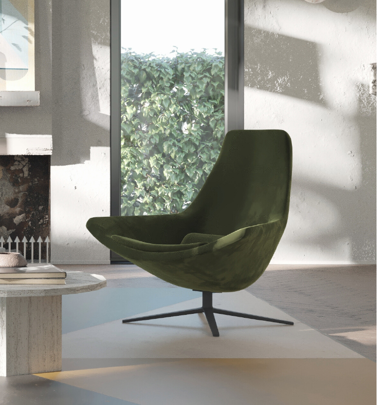 Green mid-century lounge chair with a metal four-point base in a sunlit living room by a fireplace and coffee table.