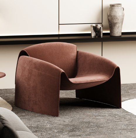 Brown curved lounge chair with wide armrests on a gray rug in a modern living room setting.